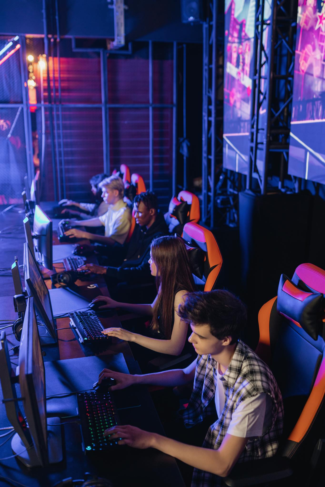 Group of diverse eSports players intensely focused in a competitive gaming environment.